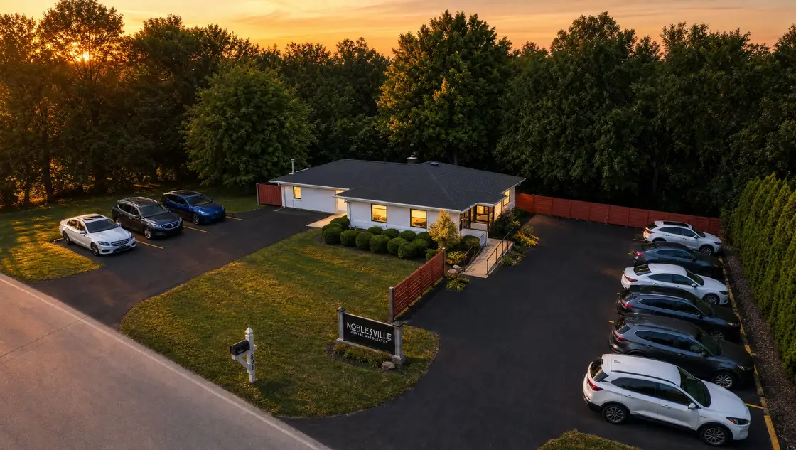 Aerial view of the Noblesville Dental Associates office on River Road at golden hour